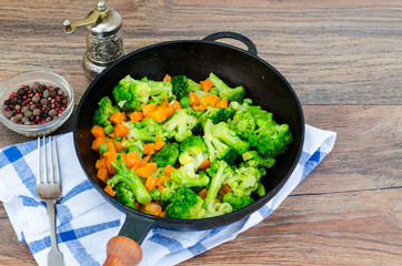 Vegetarian dish. Broccoli, carrots, green peas in pan