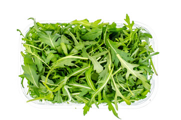 Fresh green arugula in package isolated on white background