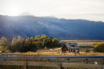 farm and barn in the utah mountain range at sunset © pureradiancecmp