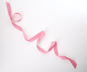 Obraz na płótnie Canvas Curled Pink Ribbon On White