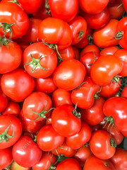 Vegetable background, texture, ripe red tomatoes in supermarket