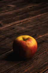 apple on wooden table vertical