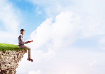 Student guy with book in hands preparing for exam