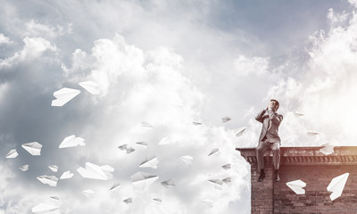 Young man on building edge do not want to see anything