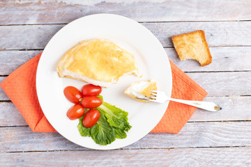fork and bite toast with egg omellete, top view