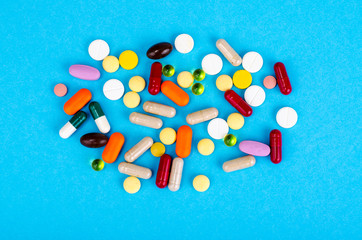 Assorted pharmaceutical medicine pills, tablets and capsules on bright background. Drugs and various narcotic substances. Copy space for text.