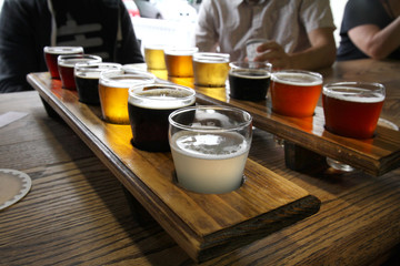 Twelve Beer Samples Being Shared at a Table