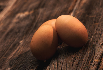 three eggs on a wood table