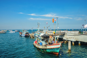 Naklejka na ściany i meble Beautiful view From Koh Lan island Pier with Fisherman Boat park near the pier.Thailand holiday concept