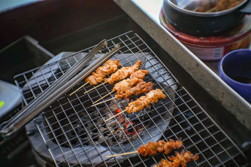 Selling Grilled crocodile Stick shop on the boat in Pattaya Floating Market in Chonburi City Thailand .Pattaya Floating Market is the Famous Floating Market near Pattaya and very Popular for Tourist