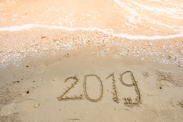 happy new year on sand background