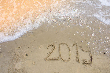 happy new year on sand background