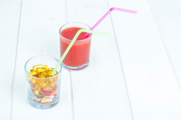 Concept of healthy lifestyle and diet. Fruits, vegetables, juices, pills and vitamin supplements