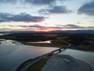 Aerial view of a beach on the Atlantic Ocean Coast during a dramatic sunrise. Taken in Codroy Valley, Newfoundland, Canada.