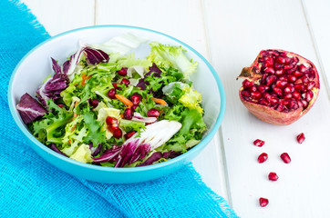 Fresh green salad with pomegranate, vegetarian menu