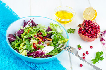 Fresh green salad with pomegranate, vegetarian menu