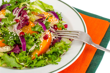 Salad with persimmon and sesame seeds, healthy food.