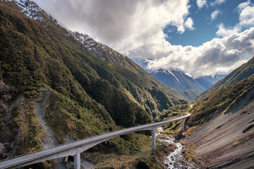 Driving in New Zealand is the best way to visit New Zealand. There are spectacular landscape and valley. In this image, a highway travels across the steep valley and gorges of Arthur's Pass.