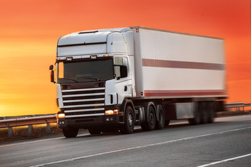 truck goes on highway on sunset