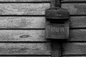 Old-fashioned mailboxes on wooden wall