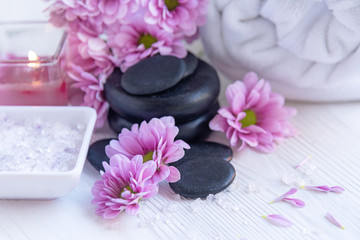 Fototapeta na wymiar Spa treatment and product for femalespa with pink flower and rock stone, copy space, select focus, Thailand. Healthy Concept