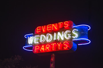 Fifties style roadside neon sign advertising weddings, events & party venue