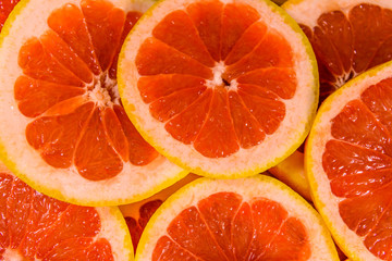 Background of sliced juicy grapefruit. Healthy eating