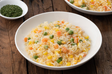 Fried rice in white plate on wood 