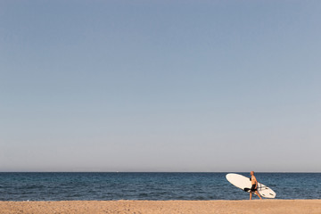 SUP stand up paddle board Man walking on the beach