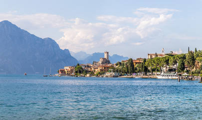Idyllic coast in Italy: Blue water and a cute village at lago di garda, Malcesine