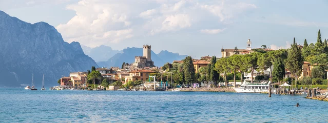 Fotobehang Kust Idyllic coast in Italy: Blue water and a cute village at lago di garda, Malcesine  © Patrick Daxenbichler