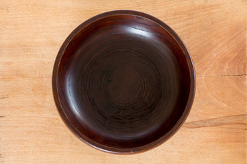 Wooden plate on wooden background