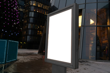 city billboard for outdoor advertising. glowing box. in the modern city in the evening.