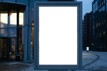 city billboard for outdoor advertising. metal glowing box. in the modern city in the evening.