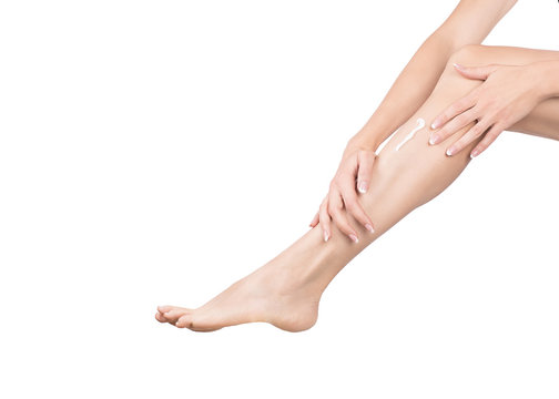 Female hands massage female leg with cream, close up, isolated on white