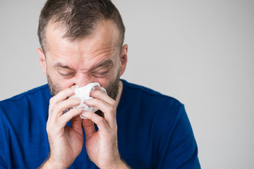 Man blowing nose