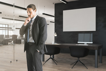 Businessman in office with banner