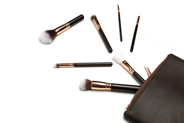 Make up bag with cosmetics brushhes isolated on white