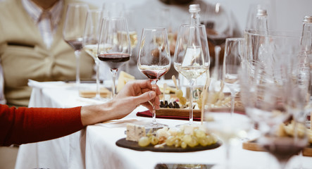 A glass of red wine in hand