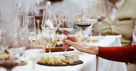 A glass of red wine in hand