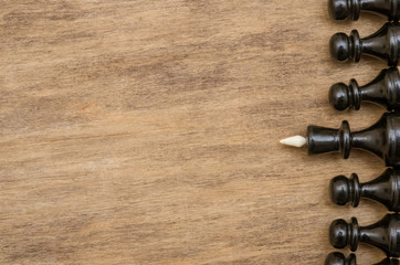 black hess figures on the brown wooden table background