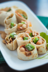 Sushi-Style Wraps with chicken pepperoni, vegetables and nuts. Healthy snacks.