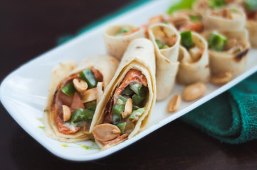 Sushi-Style Wraps with chicken pepperoni, vegetables and nuts. Healthy snacks.
