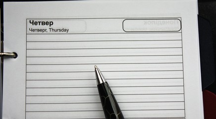 Organizer or planner with a black expensive pen