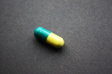 antibiotic pill on black background
