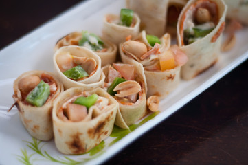 Sushi-Style Wraps with chicken pepperoni, vegetables and nuts. Healthy snacks.