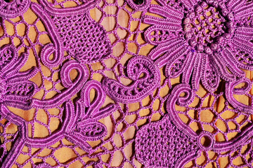 Crochet knitting. Lace of flowers. Pattern of knitted pink mesh. Handmade Irish lace as a background.