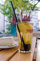 Glass of Homemade Lemonade with Fresh Fruits on Wooden Table