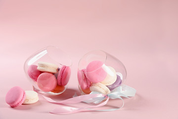 Two glasses with French pink macaroons on a pink background. Gift for Valentine's day. Ideal for holiday of international women's day.