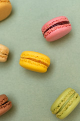Cake macaroons or macaroons on green background from above